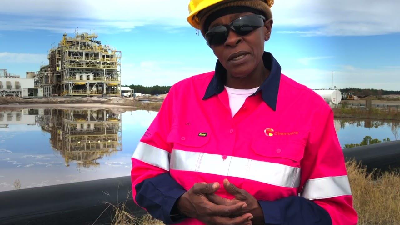 Chemours employee standing in front of a facility