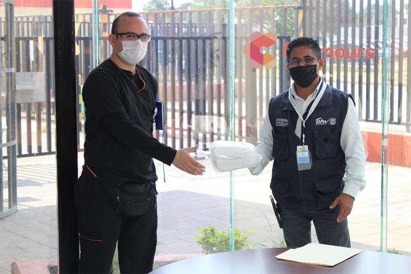 An image of two men handling donations at a Chemours facility.