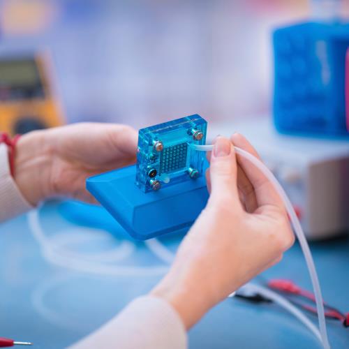 hands connecting a wire to a semiconductor