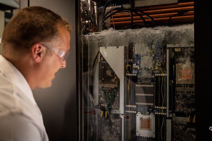 man looking at liquid cooled device