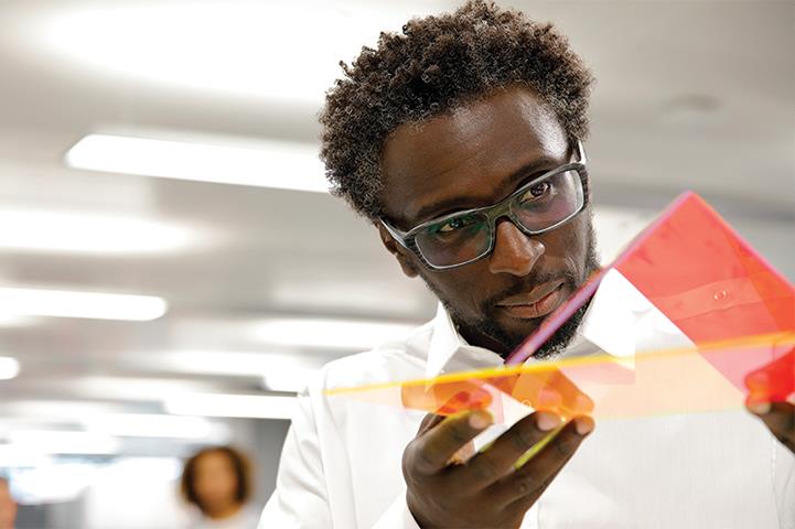 Man in glasses holding transparent plastics