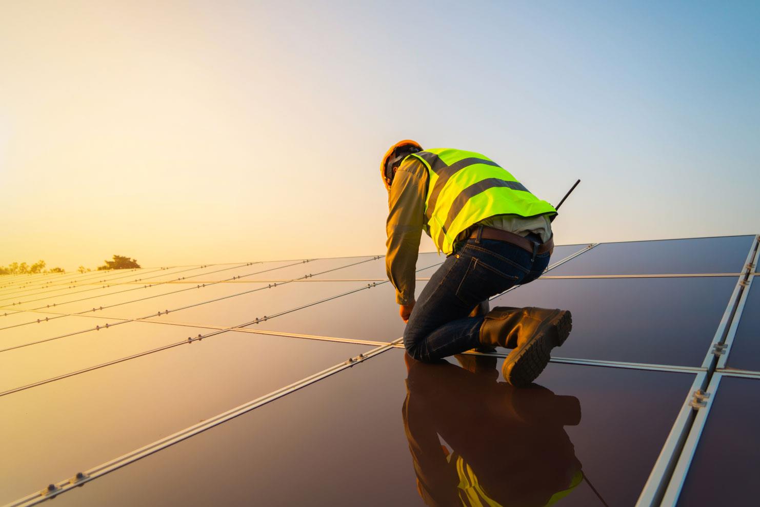Man fixing solar panel array