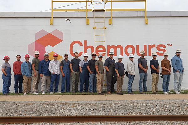Chemours team lined up next to a Chemours building