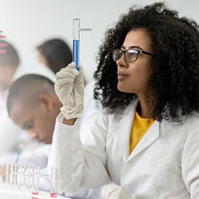 A young Black student in a chemistry lab. 