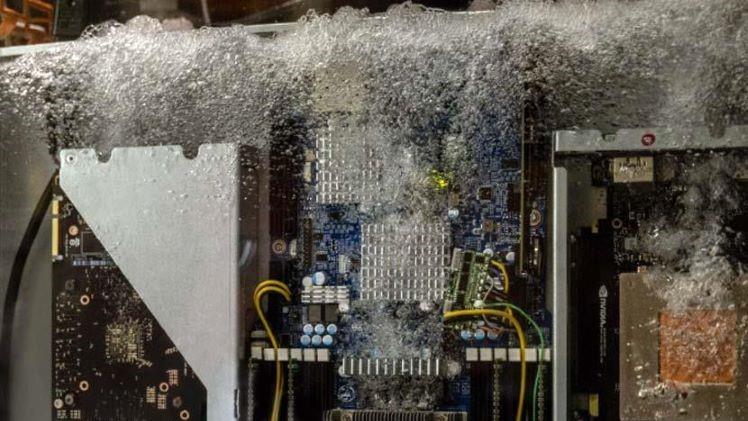 electronic device submerged in liquid cooling fluid