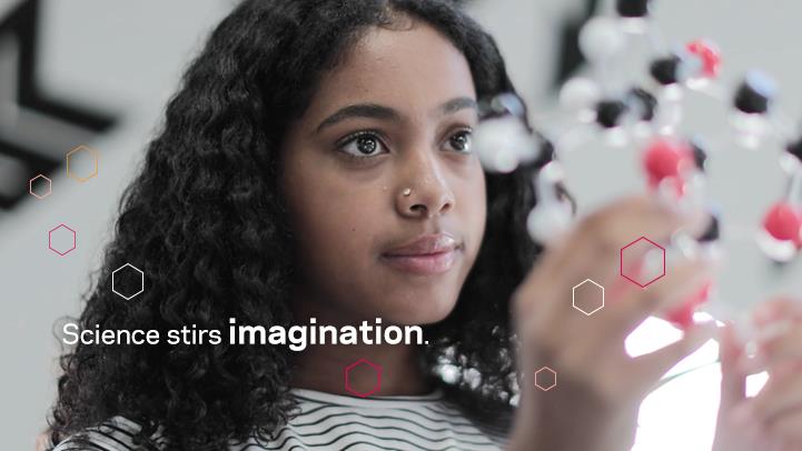 young woman holding molecular structure sample
