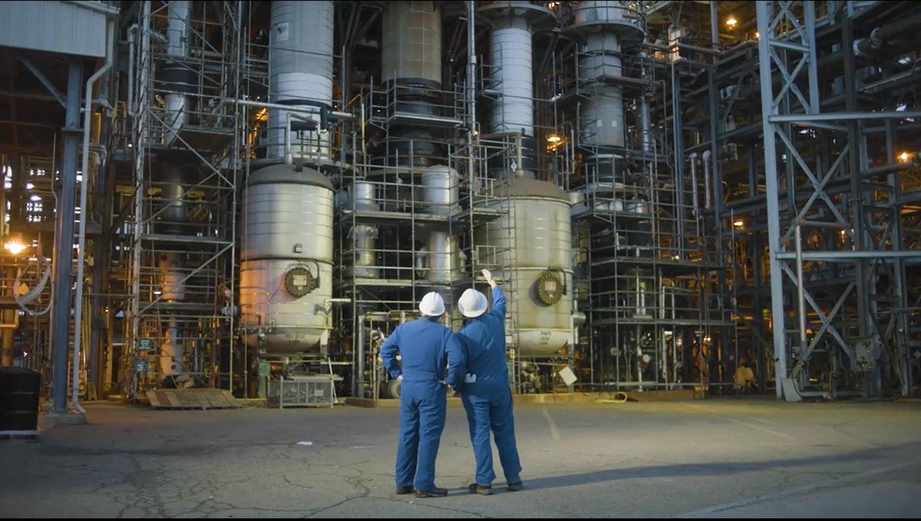 Two men talking in front of  the Washington Works manufacturing facility.