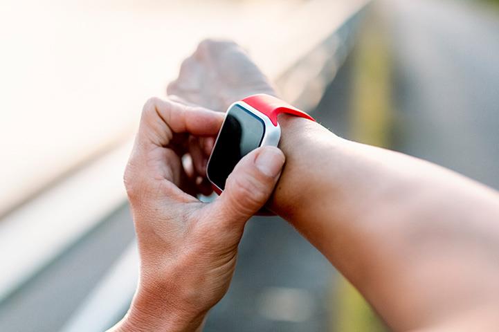 person adjusting smartwatch on right wrist